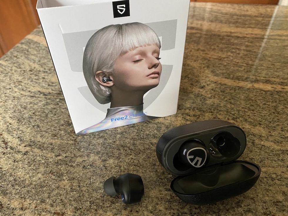 a photo of Free2 Classic earbuds box, earbud and charging case