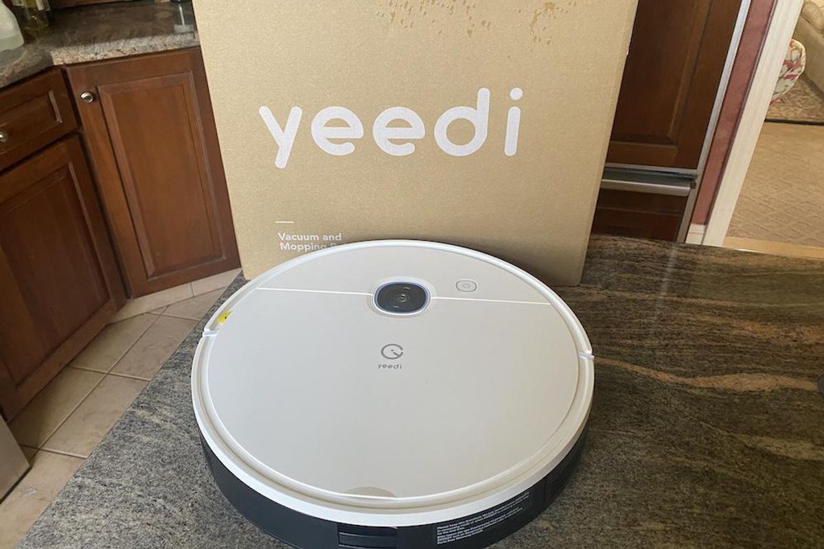 photo of yeedi vac robot vacuum and mop on a countertop unboxed.