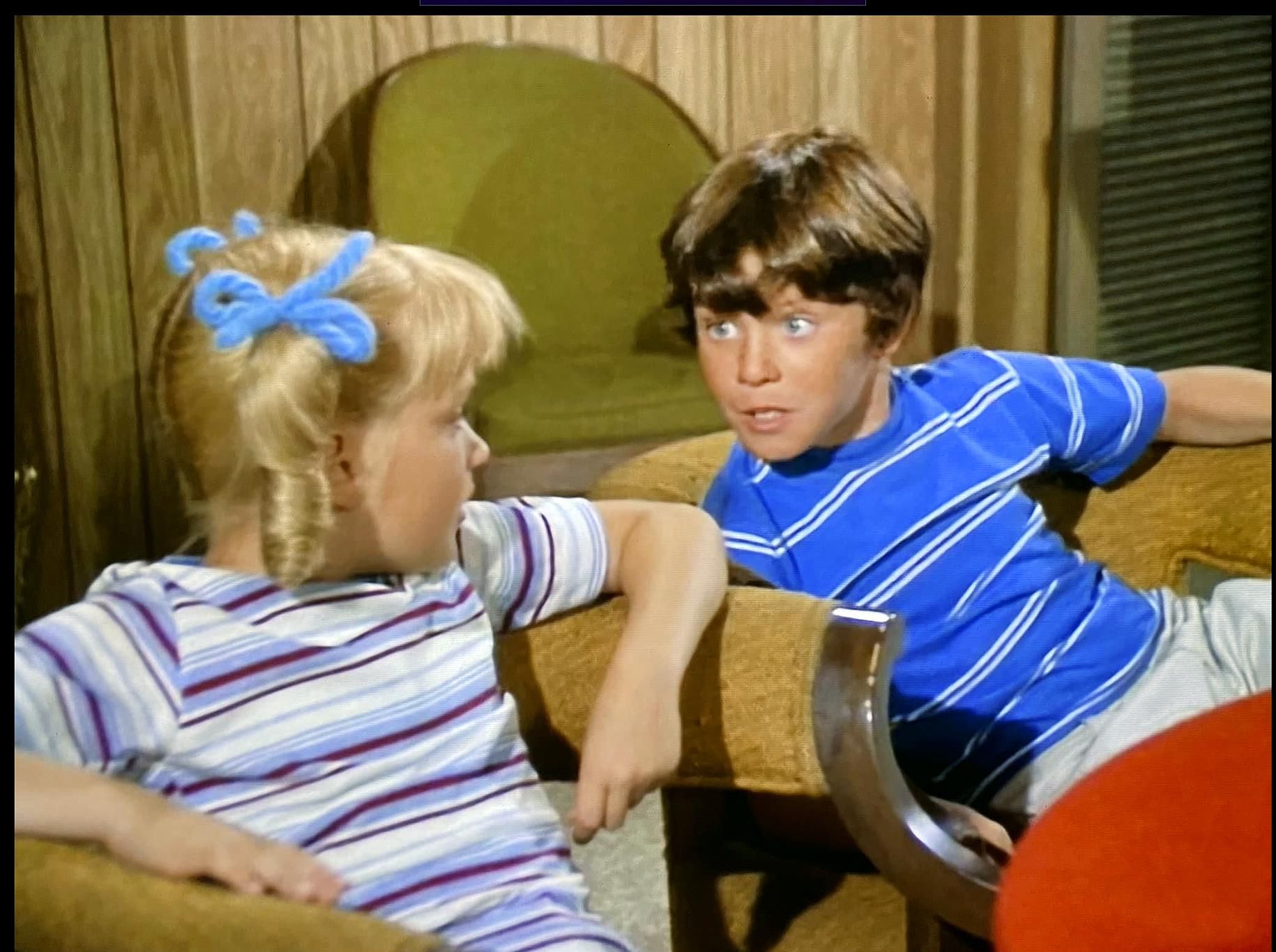 Bobby and Cindy talk excitedly in the rec room of the Brady House