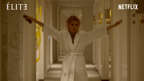 Woman walking down a hall in a robe