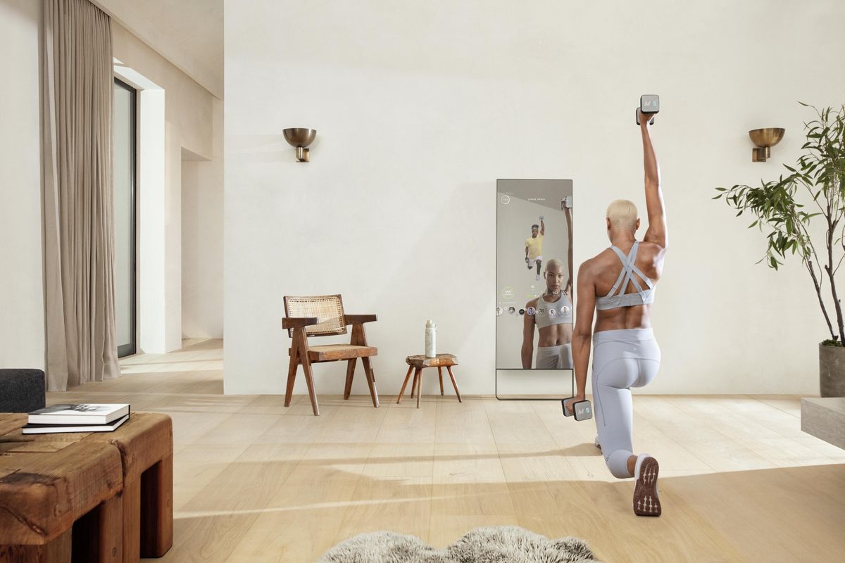 A woman working out with The MIRROR
