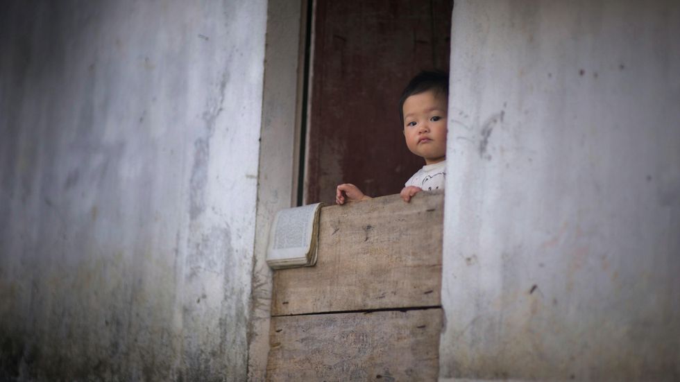 CCTV shows the heart-stopping moment a passerby catches a toddler falling from a building