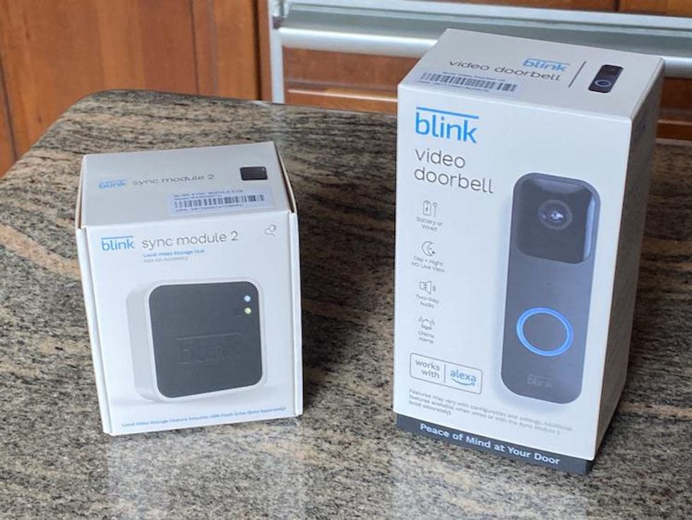 a photo of Blink Video Doorbell  and Sync Module 2 boxes on a countertop