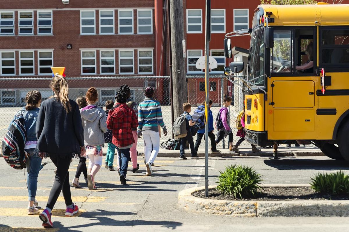 photo of kids going back to school in a crossing lane