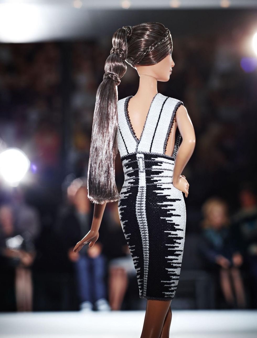 The Hervé Léger by Max Azria Barbie wears a scarlet bandage dress 