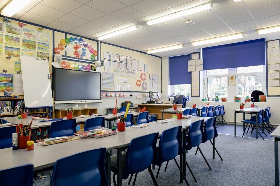 a photo of an empty classroom with a smart whiteboard