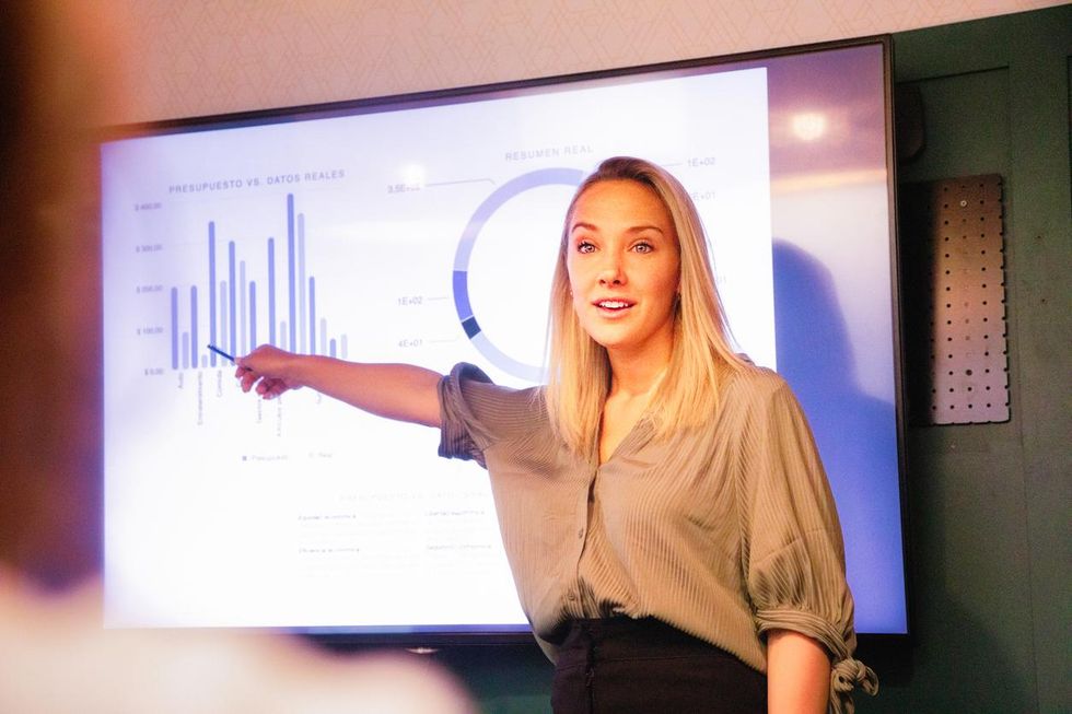 a photo of a teacher using a smart projector in the classroom