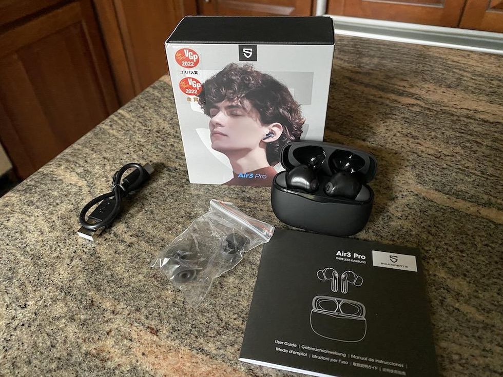 a photo of Soundpeats Air3 Pro ANC earbuds unboxed on a countertop