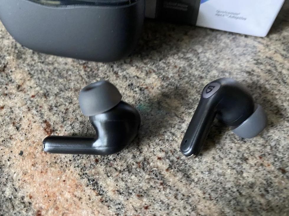 a photo of soundpeats Air3 Pro Hybrid ANC earbuds on a countertop