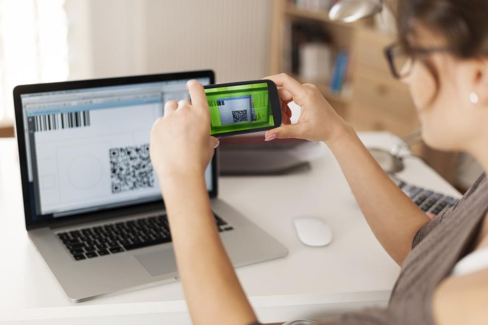 a woman scanning a bar code on her smartphone