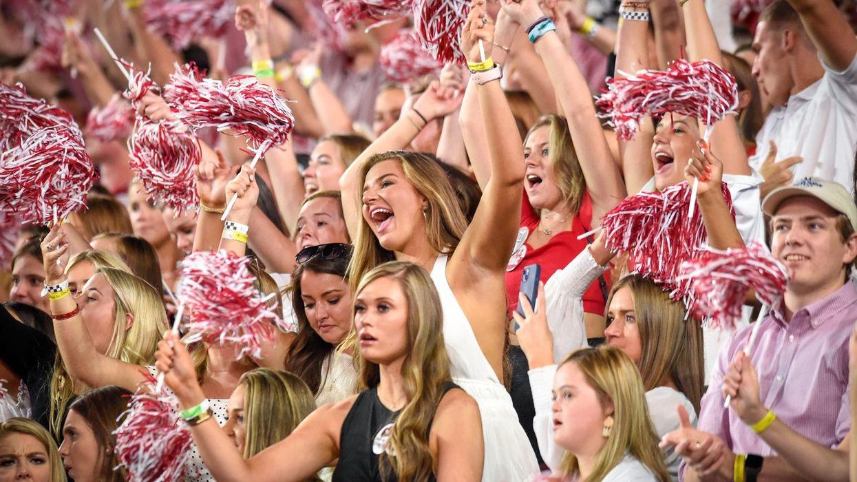 The crowd cheers at a University of Alabama football game.