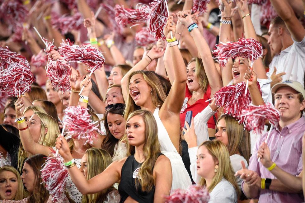 Alabama fans cheer at a football game.