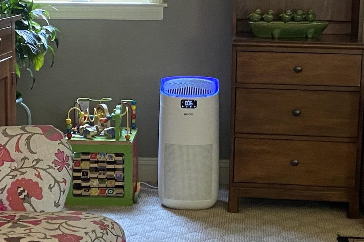 a photo of Afloia Smart Air Purifier in a room with UV-C light on
