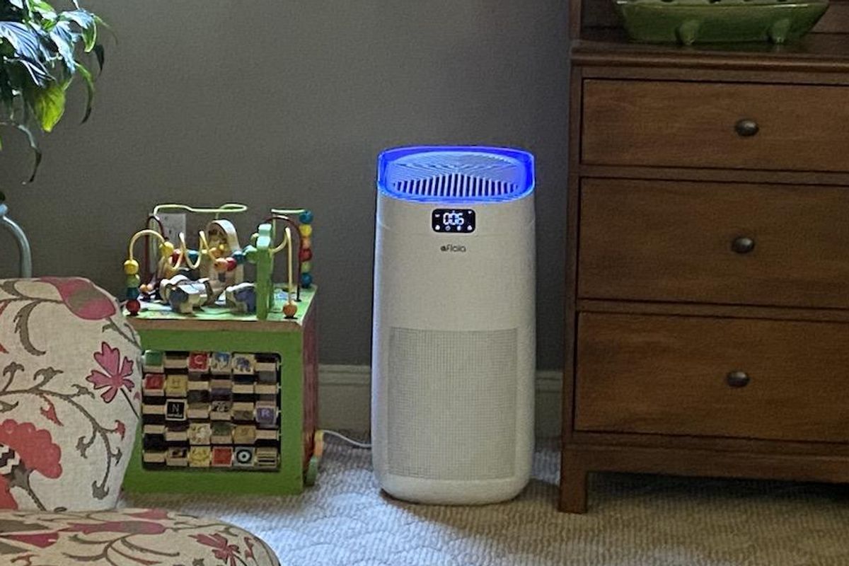 a photo of Afloia Smart Air Purifier in a room with UV-C light on