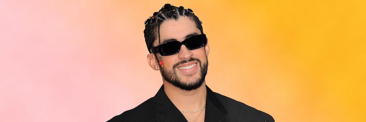 Image of the artist Bad Bunny wearing sunglasses in front of a pink and orange ombre background