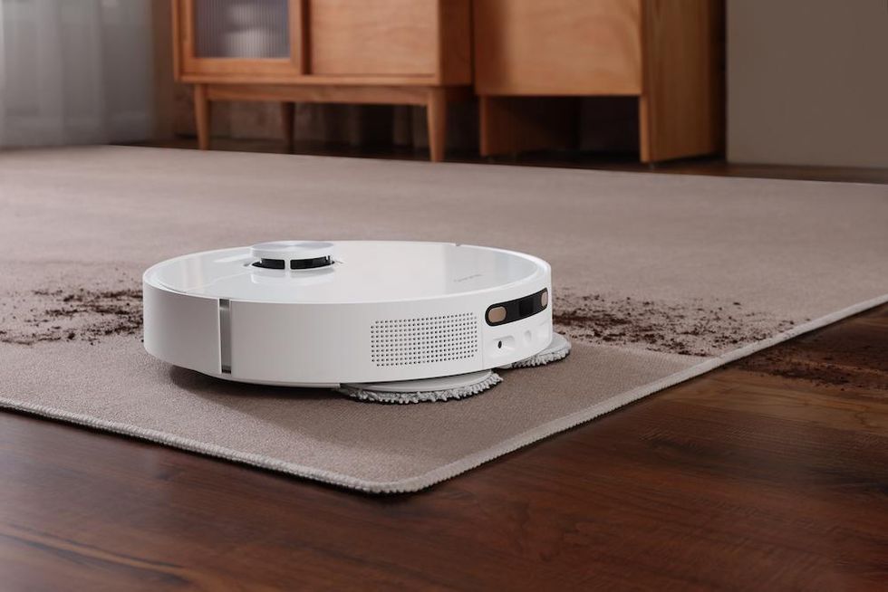 a photo of new DreameBot L10s Ultra on a carpet cleaning