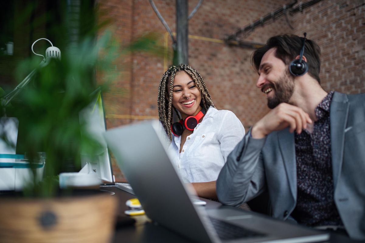 Diverse young professionals chatting at work