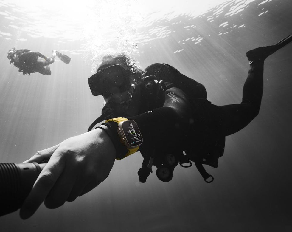 a photo of Apple Watch Ultra on a scuba diver underwater.