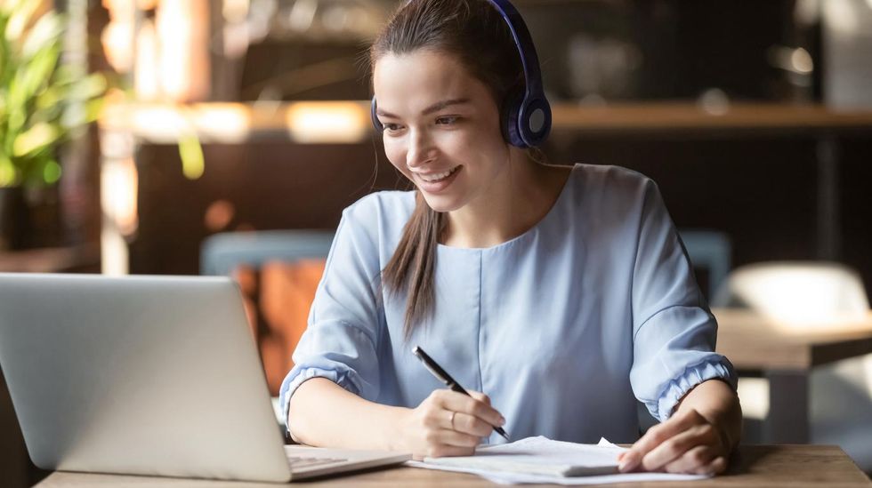 a photo of a girl on her laptop watching her teacher