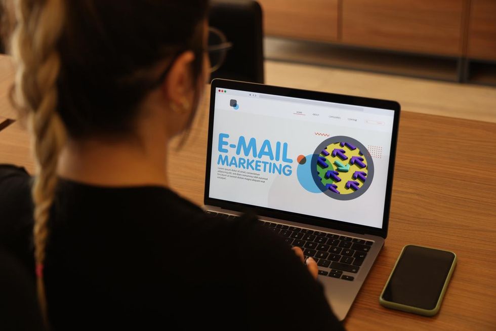 a photo of a woman on a computer showing email marketing info