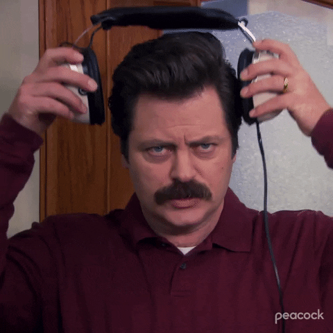 Nick Offerman as Ron Swanson puts on headphones