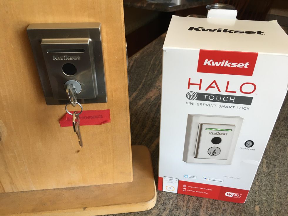 a photo of Kwikset Halo Touch Fingerprint Smart Lock installed and the box