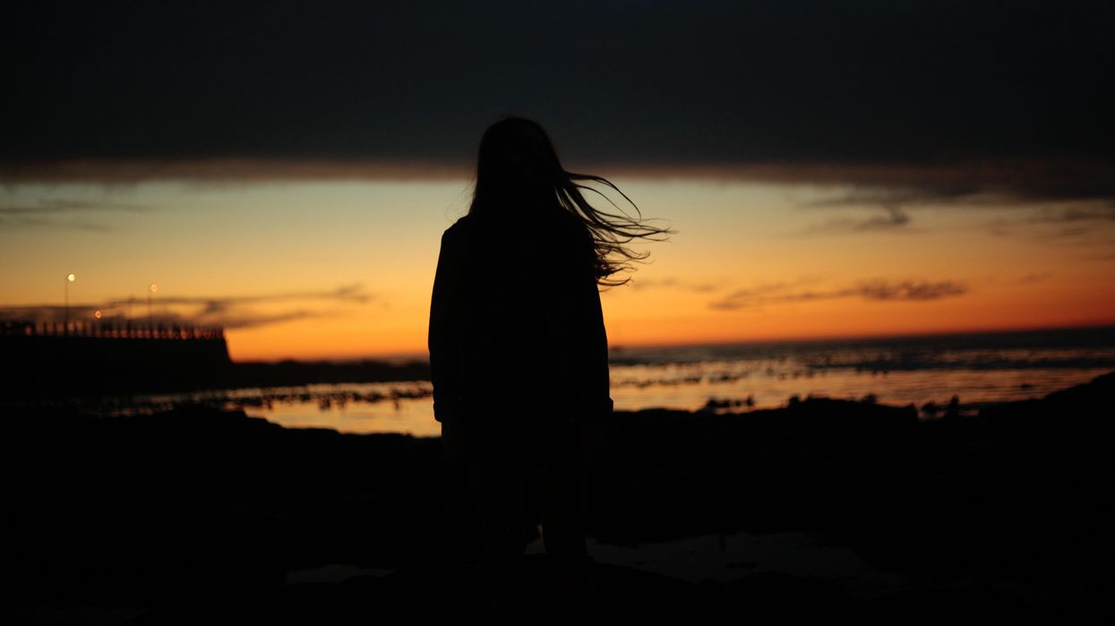 silhouette of woman near beach