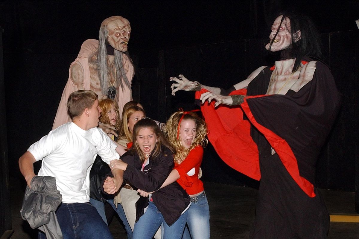 People scream at a haunted house.