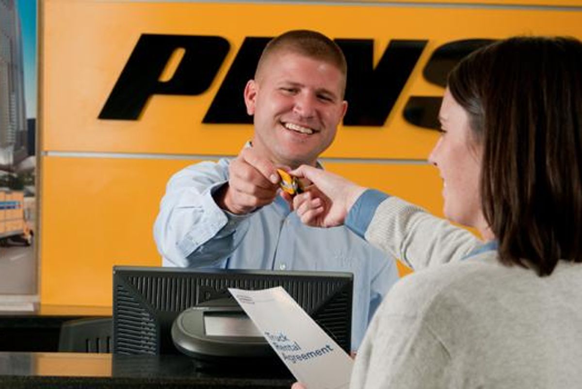 Penske associate behind the rental counter assisting a customer