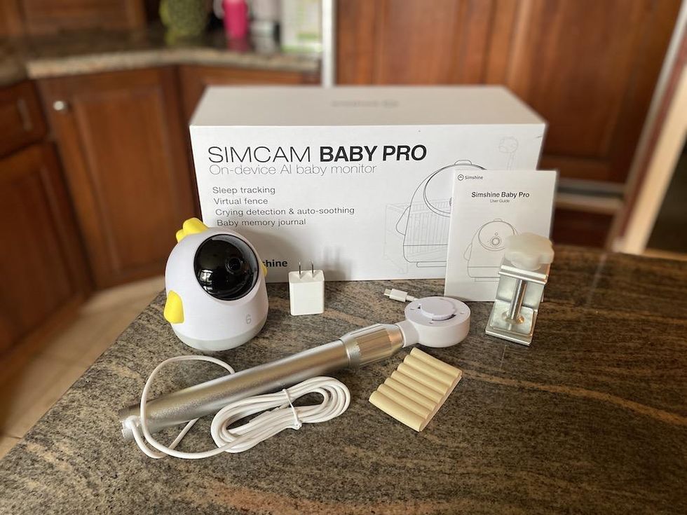 a photo of Simshine Baby Pro Monitor unboxed on a countertop