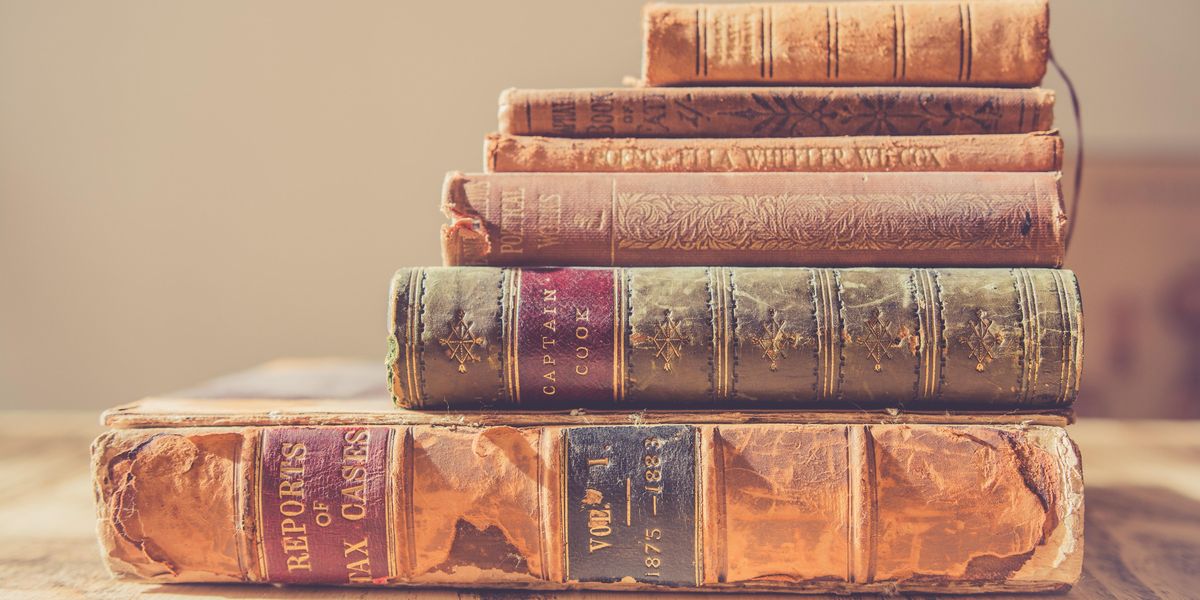 Stack of rare hardcover books.