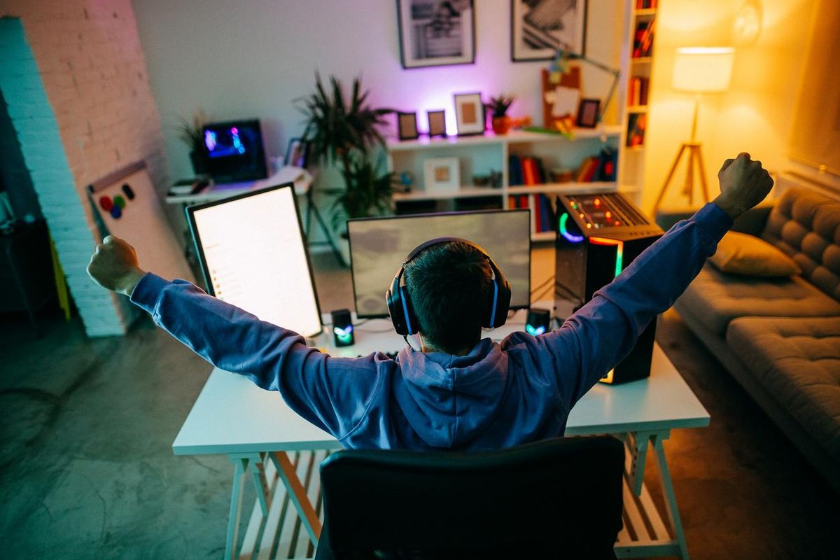 a person at a desk with smart lights, speakers and a lot of gadgets