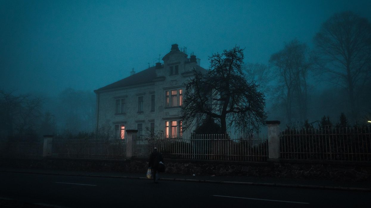 person walking towards house