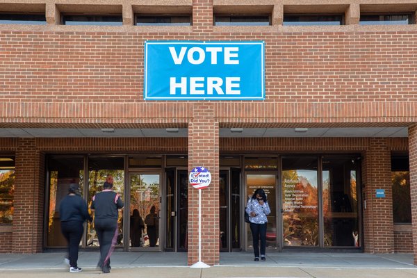 polling place with people entering and leaving