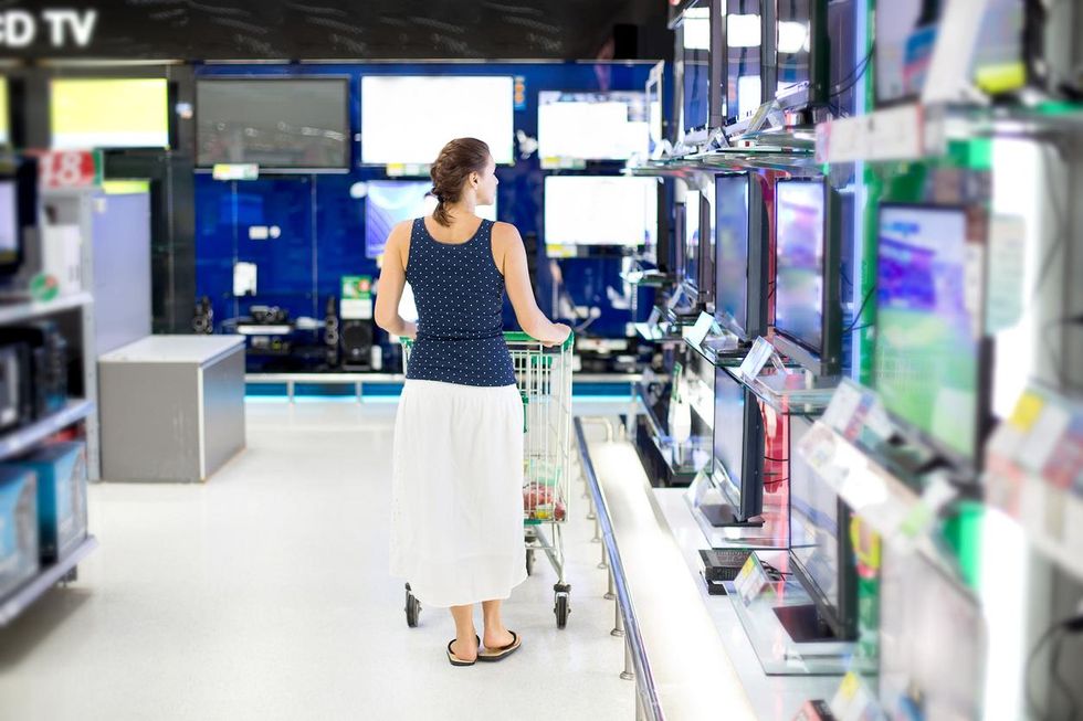 a woman shopping for a TV