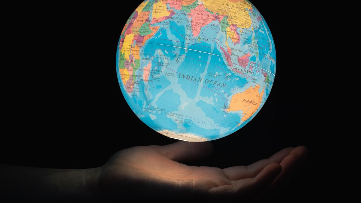 Image of a globe in the palm of someone's hand