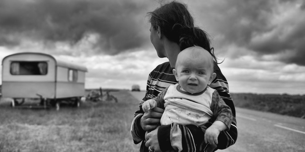 Black and white photo with a mom holding a distressed baby