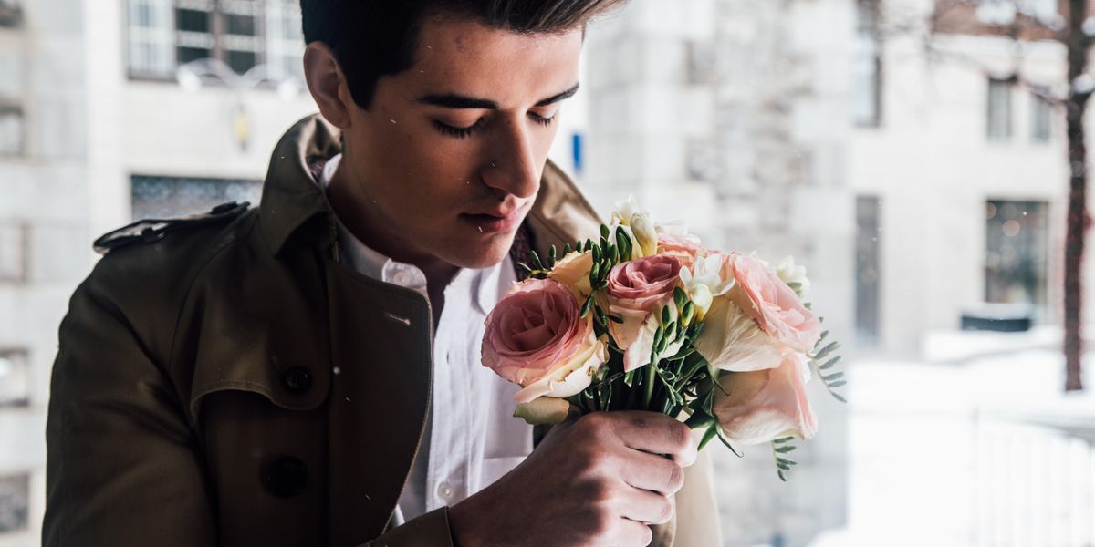 man holding pink roses