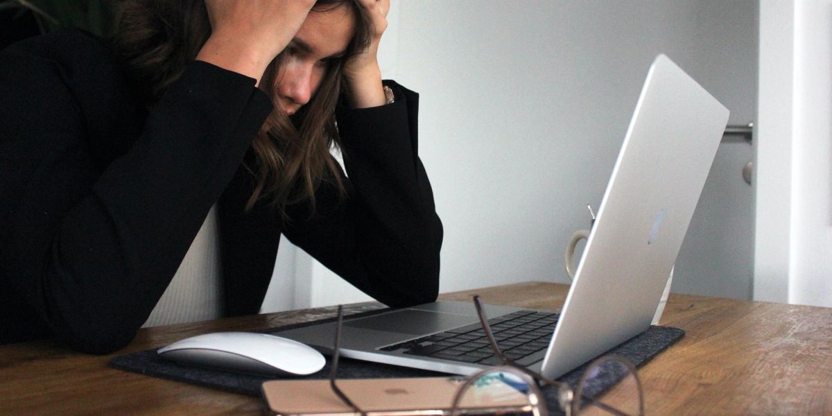 Frustrated woman looking at computer