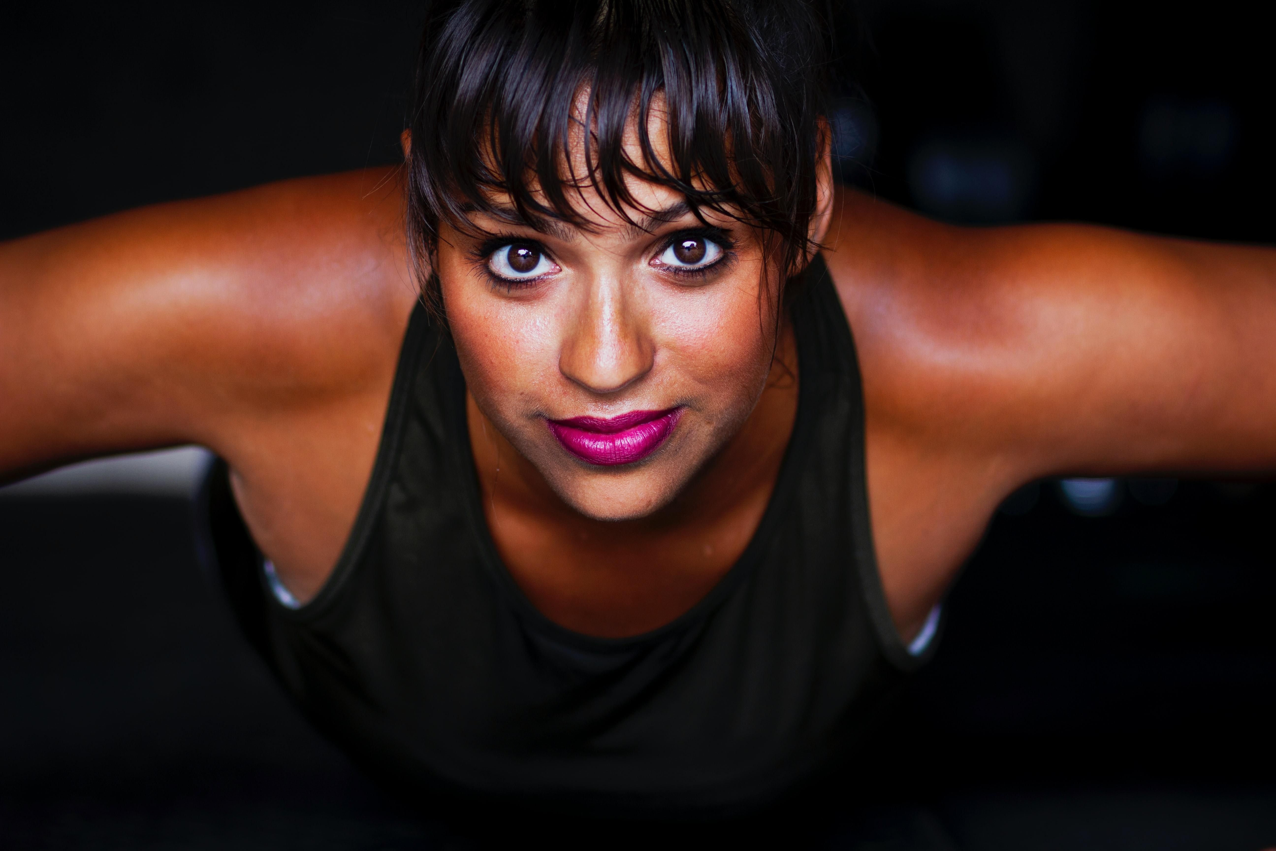 women looking into camera in black tank top