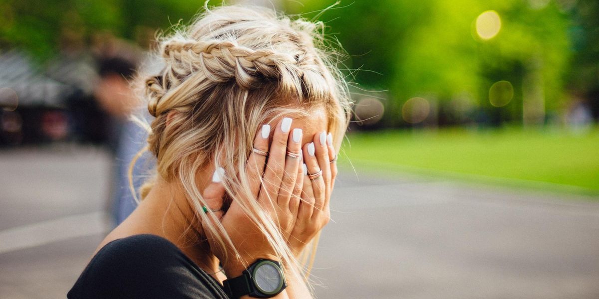 A devastated woman covers her face