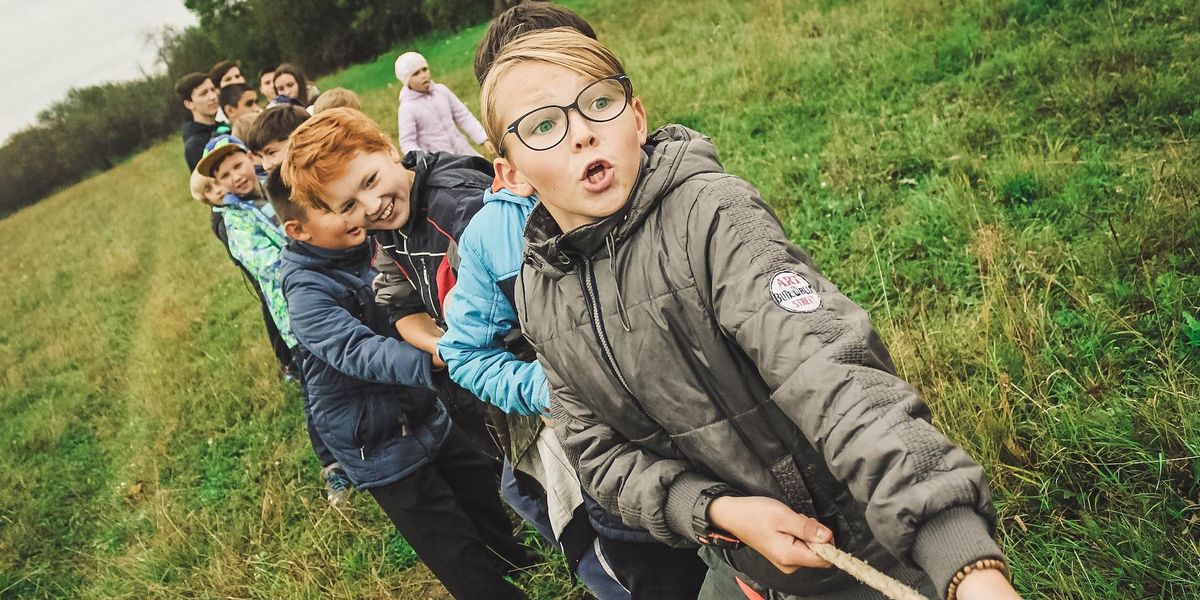 Kids pull on a rope in a tug of war