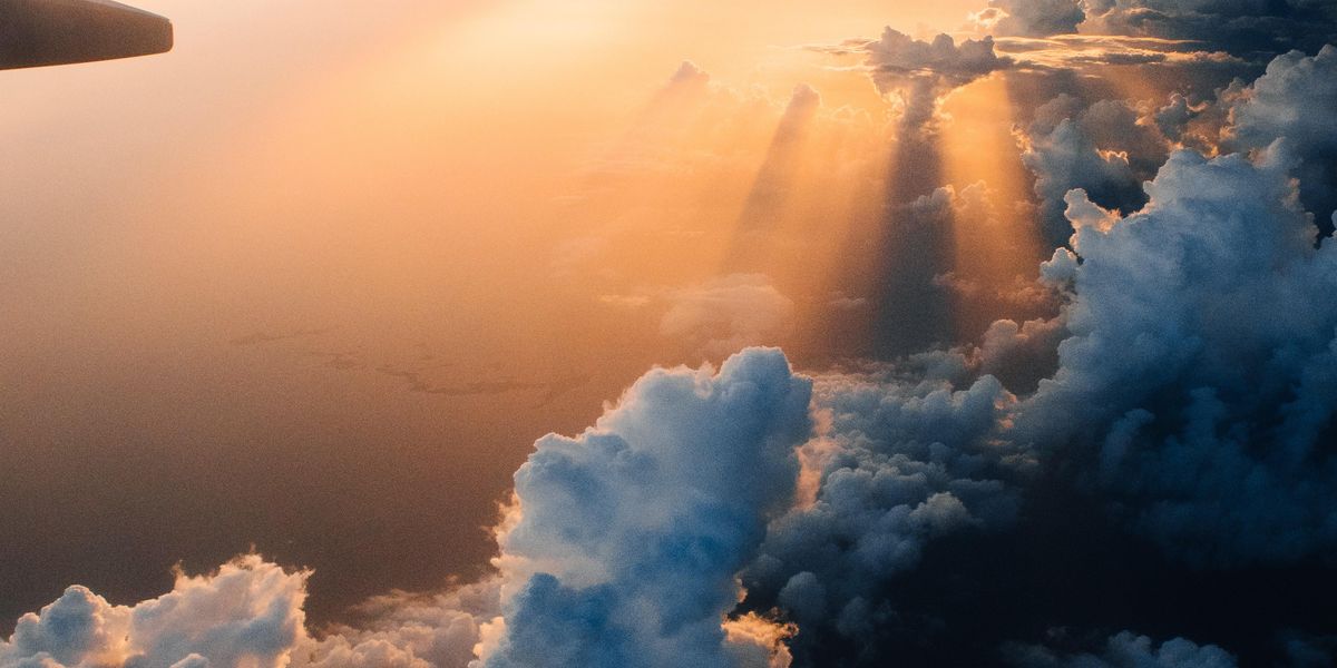 a plane wing in the clouds