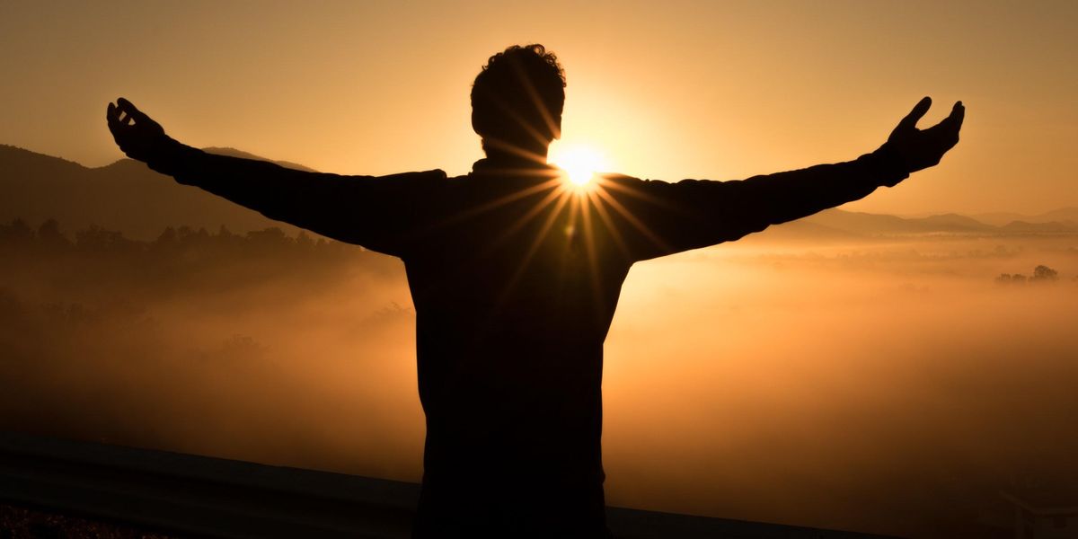 Man raising his arms to the sun