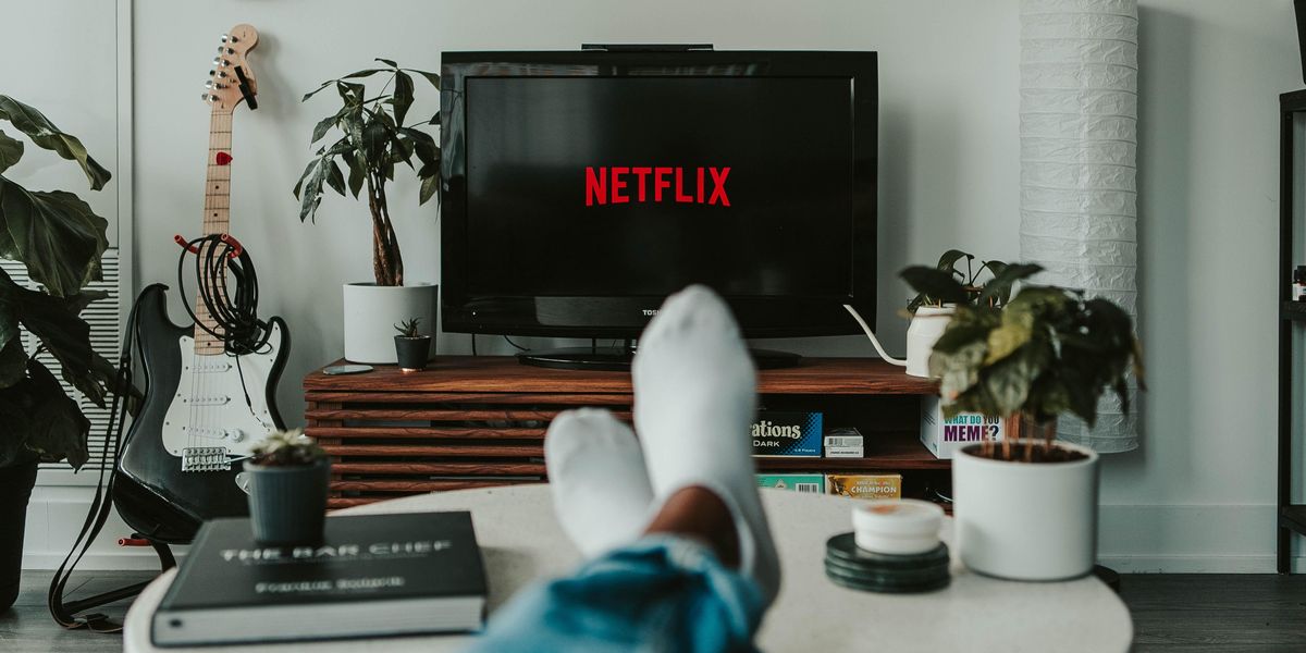 A viewer sitting in front of the TV