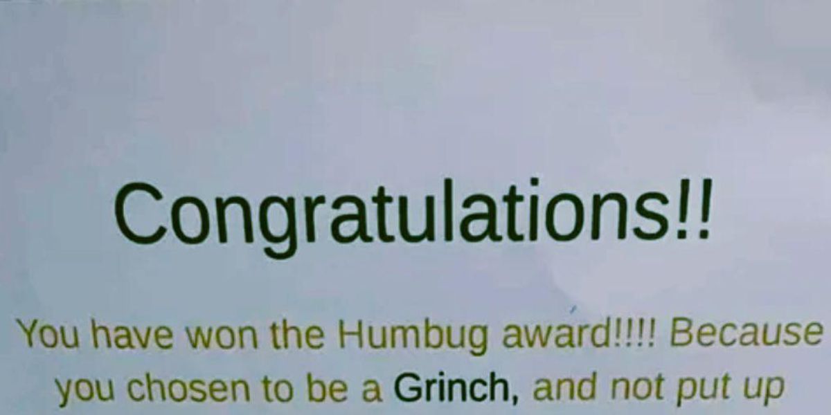Photo of a printed letter that says "Congratulations! You have won the Humbug award!!!! Because you chosen [sic] to be a Grinch, and not put up Christmas lights you have disappointed all the children, young, and old in your community!"