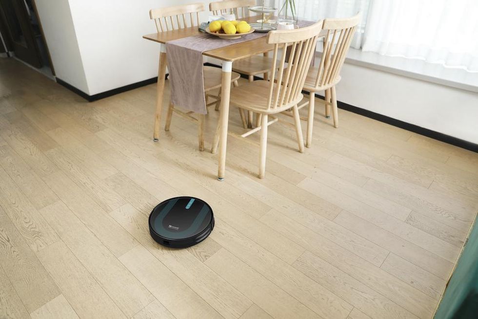a photo of Proscenic 850T robot vacuum cleaning a wood floor