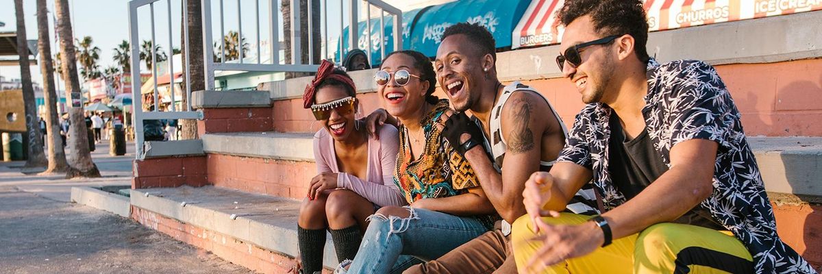 friends in rollerskates sitting on steps on the street