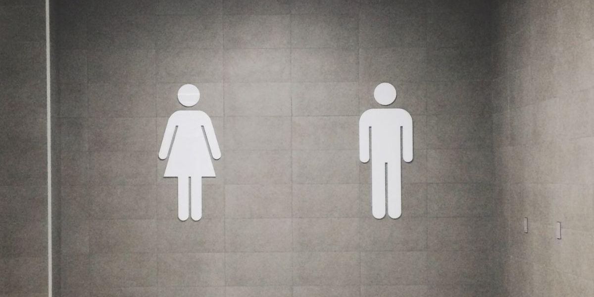 The male/female bathroom signs on a wall