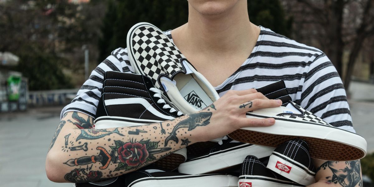 Person carrying an armload of new Vans shoes